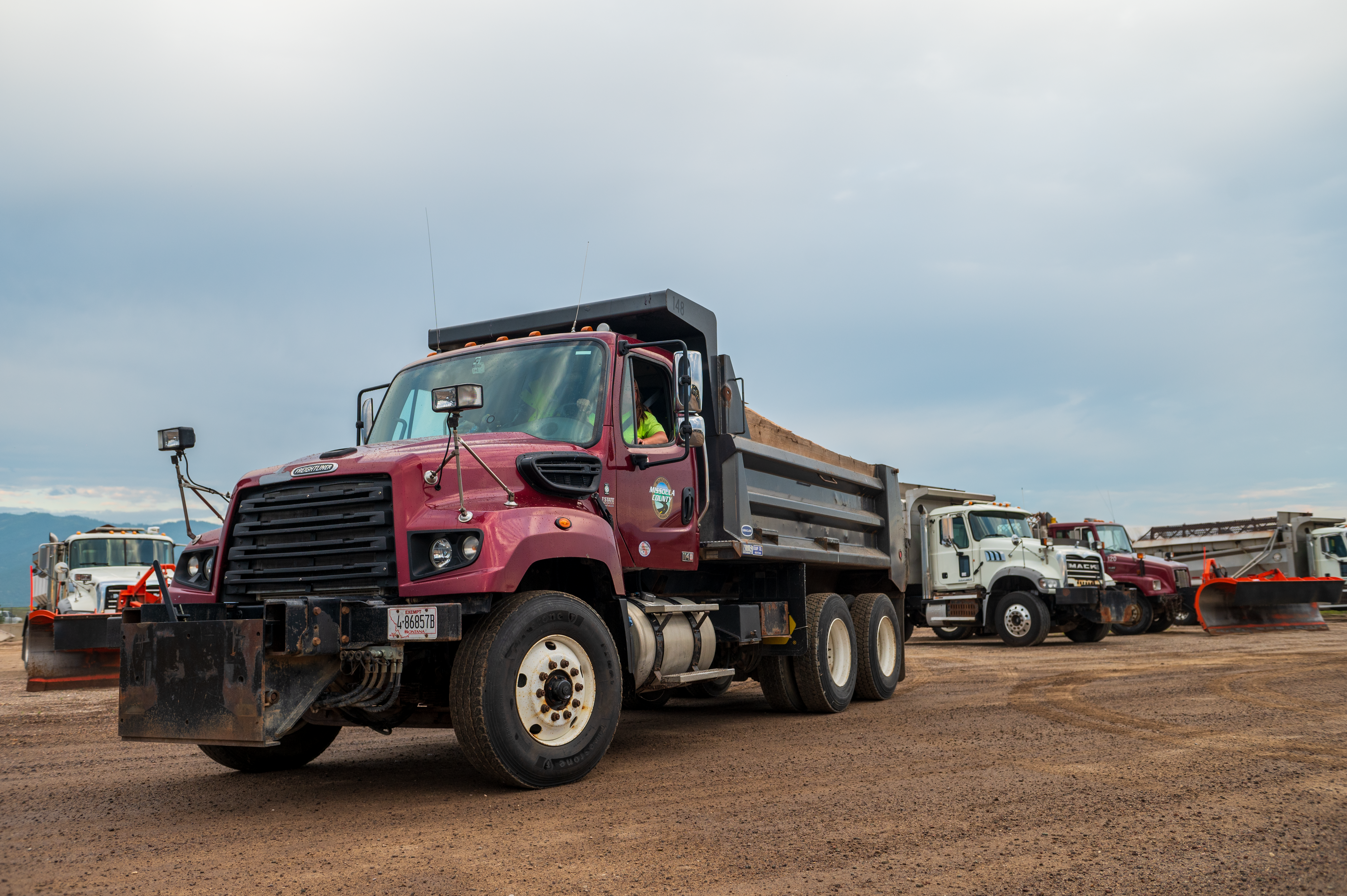 Public Works staff driving maintenance trucks