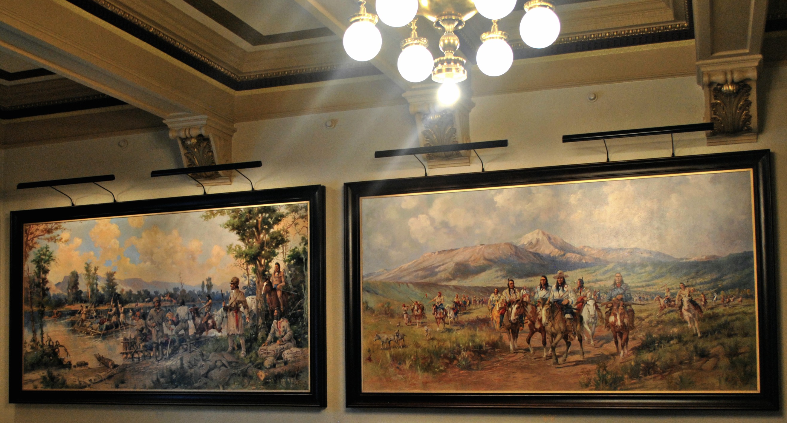 Color photo of the interior of the courthouse lobby featuring two murals painted by Edgar Paxson